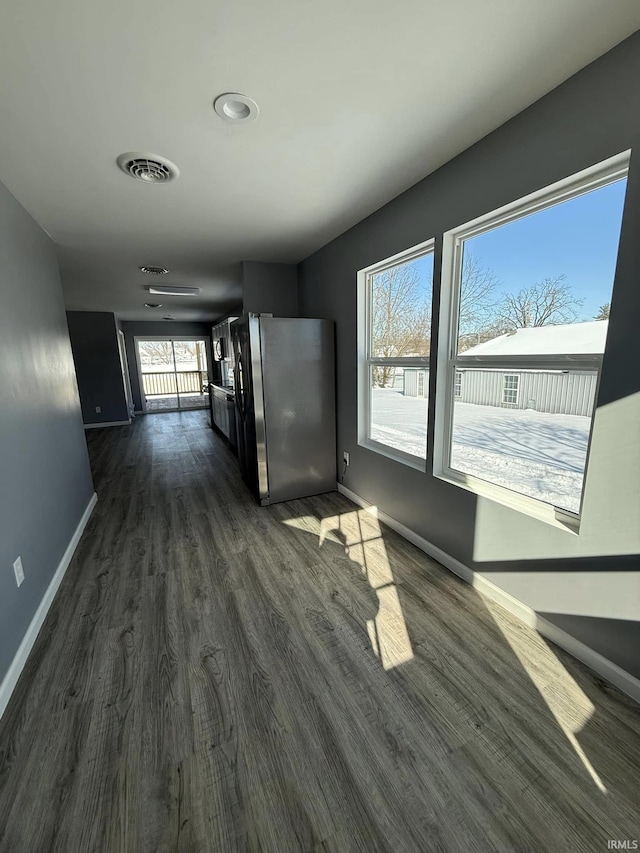 unfurnished living room with dark wood-type flooring