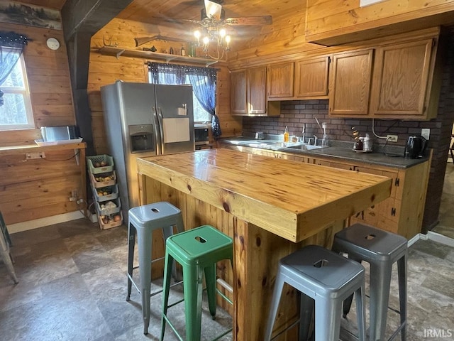 kitchen featuring sink, ceiling fan, butcher block countertops, a healthy amount of sunlight, and stainless steel fridge with ice dispenser