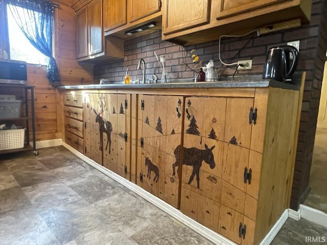 kitchen with sink, backsplash, and wood walls