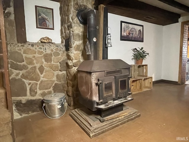 details featuring a wood stove and concrete floors