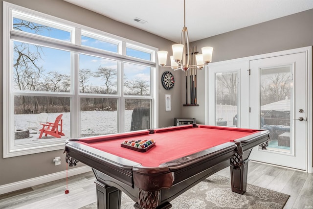 playroom featuring a notable chandelier, light hardwood / wood-style floors, and billiards