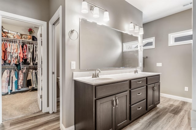 bathroom featuring vanity, hardwood / wood-style flooring, and toilet