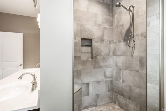 bathroom with sink and tiled shower