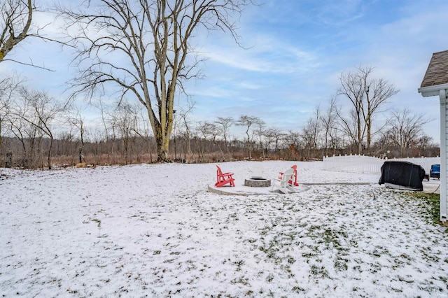 snowy yard featuring an outdoor fire pit