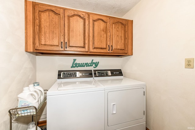 washroom with cabinets, a textured ceiling, and separate washer and dryer