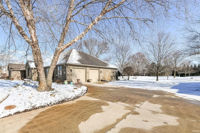 view of snowy exterior with a garage