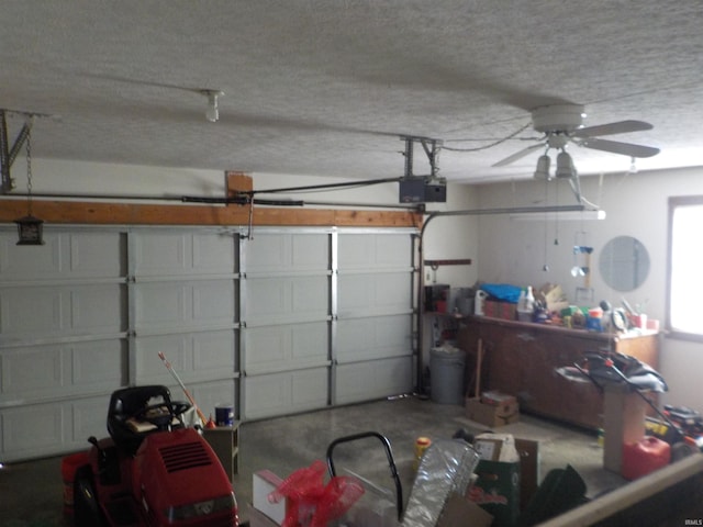 garage featuring ceiling fan and a garage door opener