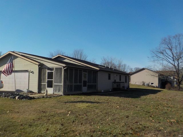 view of property exterior featuring a sunroom, a yard, and a garage