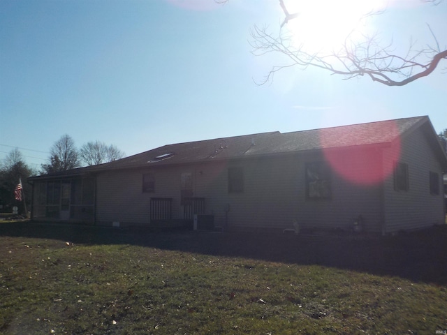 rear view of property with a yard