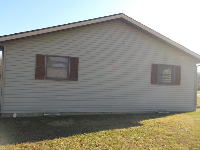 view of side of home with a lawn