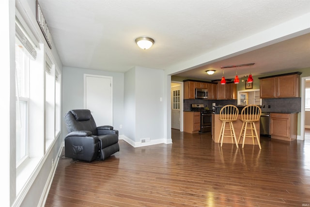 interior space with dark hardwood / wood-style floors and a healthy amount of sunlight