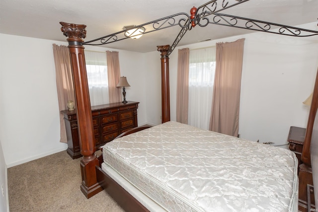 carpeted bedroom featuring multiple windows