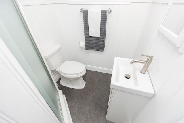 bathroom featuring vanity, hardwood / wood-style flooring, and toilet