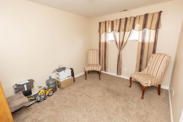 sitting room featuring carpet flooring