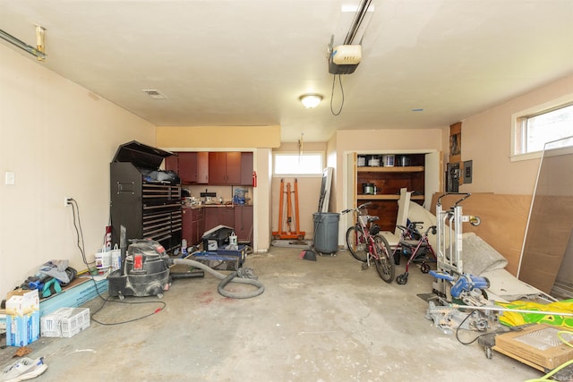 garage with a workshop area and a garage door opener