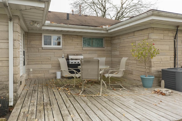 wooden terrace with area for grilling and cooling unit