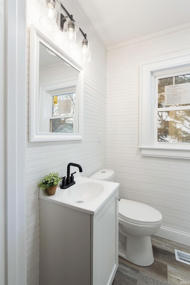 bathroom featuring vanity, hardwood / wood-style flooring, and toilet