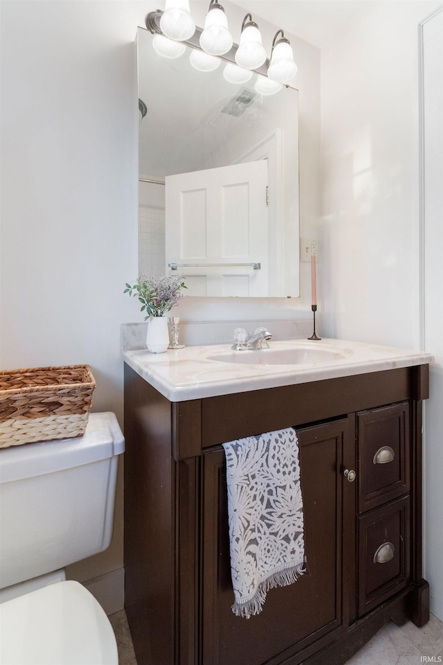 bathroom featuring vanity and toilet