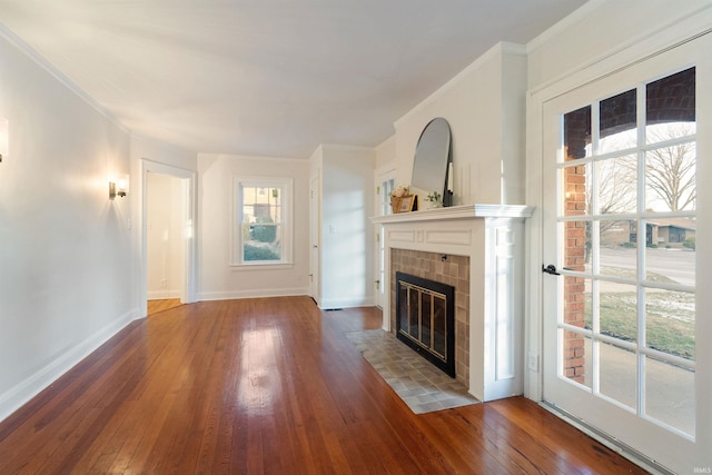 unfurnished living room featuring a fireplace, dark hardwood / wood-style floors, and ornamental molding