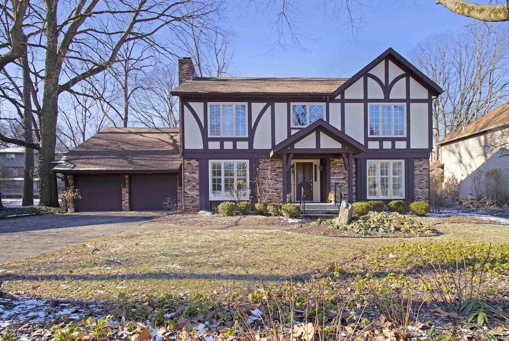 english style home featuring a garage