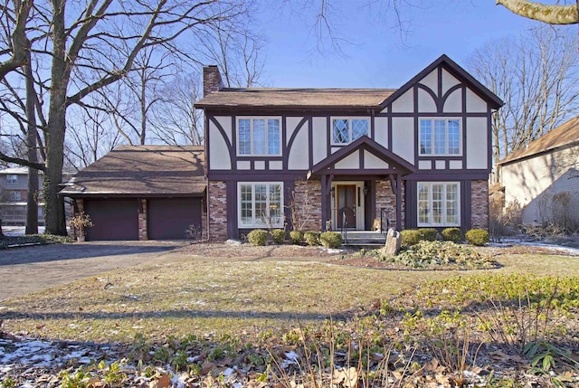 english style home featuring a garage