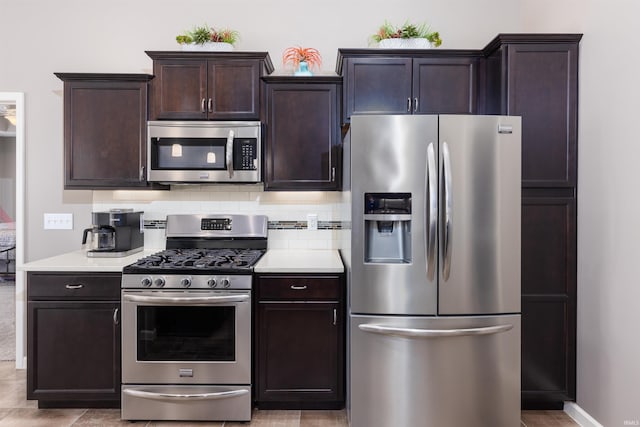 kitchen with decorative backsplash, dark brown cabinetry, and appliances with stainless steel finishes