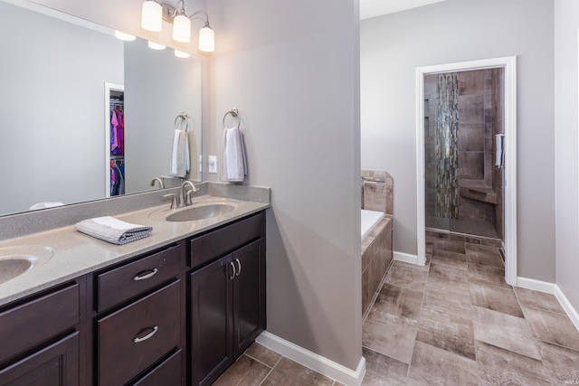 bathroom with tiled bath and vanity