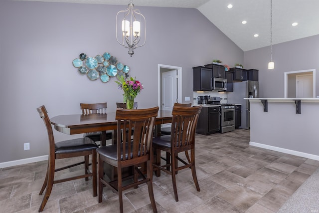 dining area with a notable chandelier and high vaulted ceiling