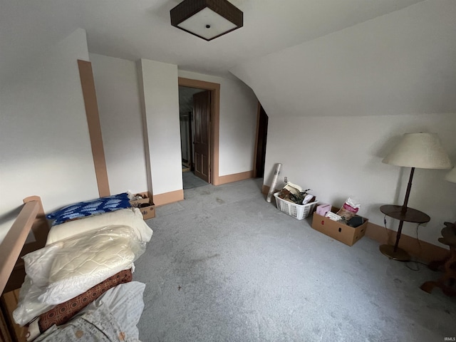 additional living space featuring light colored carpet and vaulted ceiling