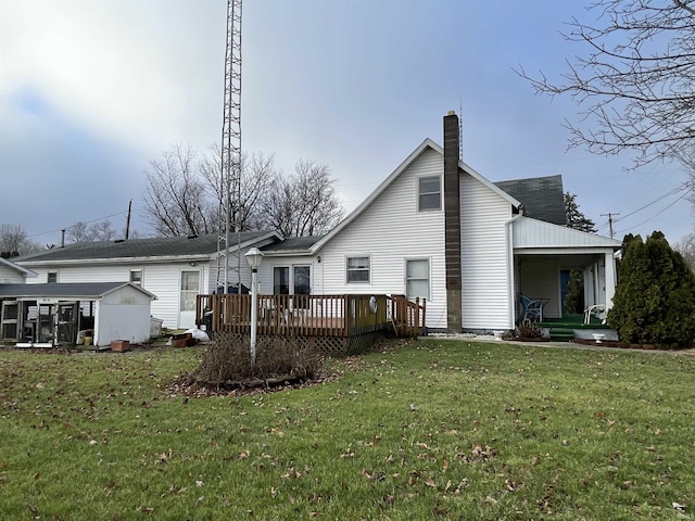 back of house featuring a lawn and a deck