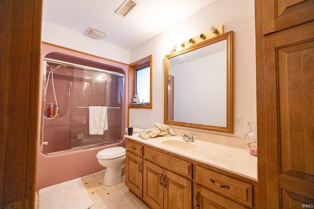 full bathroom with tile patterned flooring, vanity, toilet, and bath / shower combo with glass door