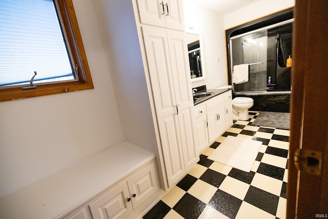 full bathroom with vanity, toilet, and shower / bath combination with glass door