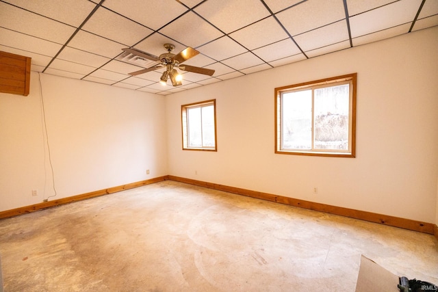 spare room featuring ceiling fan, a drop ceiling, and light carpet