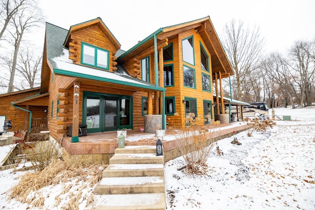 snow covered property with french doors