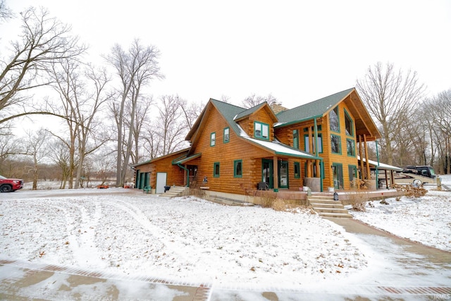 snow covered property with a porch