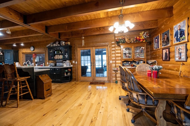 dining area featuring beam ceiling, log walls, wooden ceiling, and an inviting chandelier