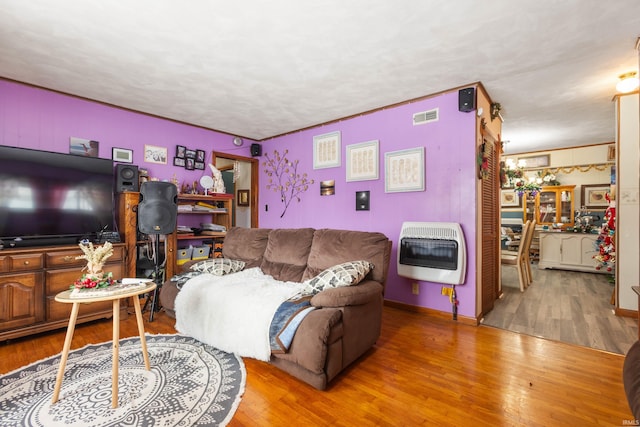 living room featuring hardwood / wood-style floors and heating unit