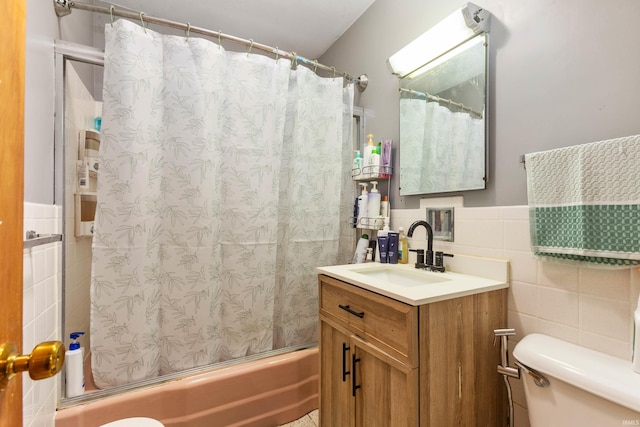 full bathroom with vanity, shower / bath combination with curtain, tile walls, and toilet