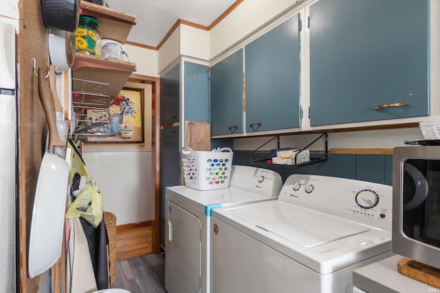 clothes washing area with dark hardwood / wood-style flooring, cabinets, separate washer and dryer, and ornamental molding