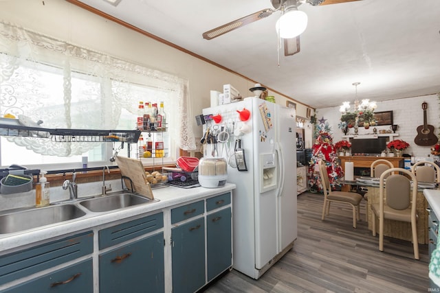 kitchen with dark hardwood / wood-style flooring, brick wall, blue cabinets, sink, and white refrigerator with ice dispenser