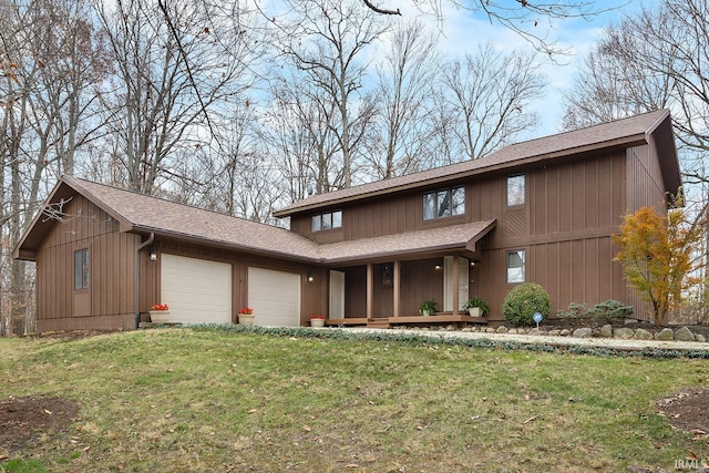 view of front of home with a front lawn and a garage