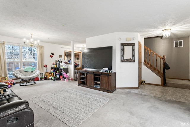 living room featuring a chandelier, a textured ceiling, and light colored carpet