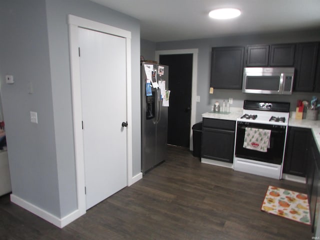 kitchen featuring appliances with stainless steel finishes and dark wood-type flooring