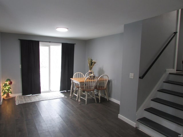 dining space with dark hardwood / wood-style flooring