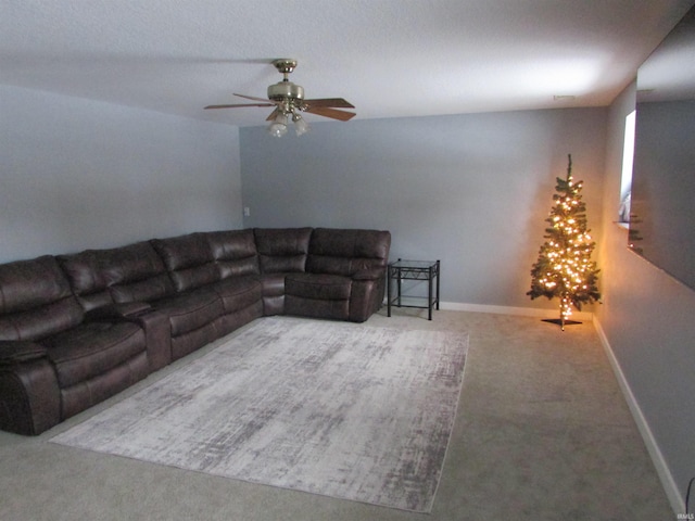 carpeted living room featuring ceiling fan