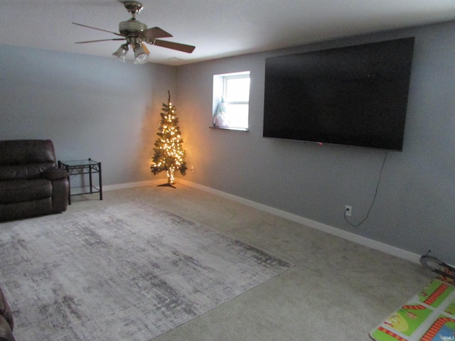 unfurnished room with ceiling fan and carpet