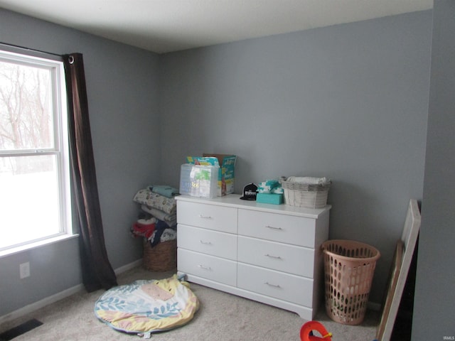 carpeted bedroom featuring multiple windows