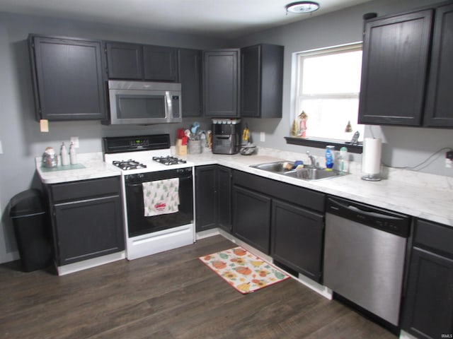 kitchen with dark hardwood / wood-style flooring, sink, and stainless steel appliances