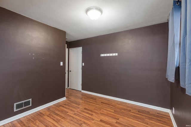 spare room with hardwood / wood-style floors