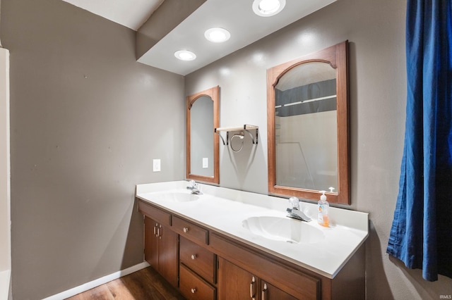 bathroom with hardwood / wood-style floors and vanity